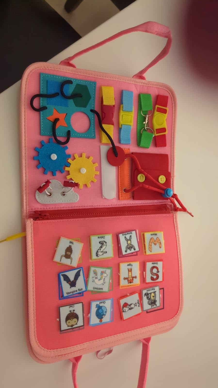 Avis Busy board Montessori rose pour bébé 1 à 4 ans : jouet éducatif avec puzzle